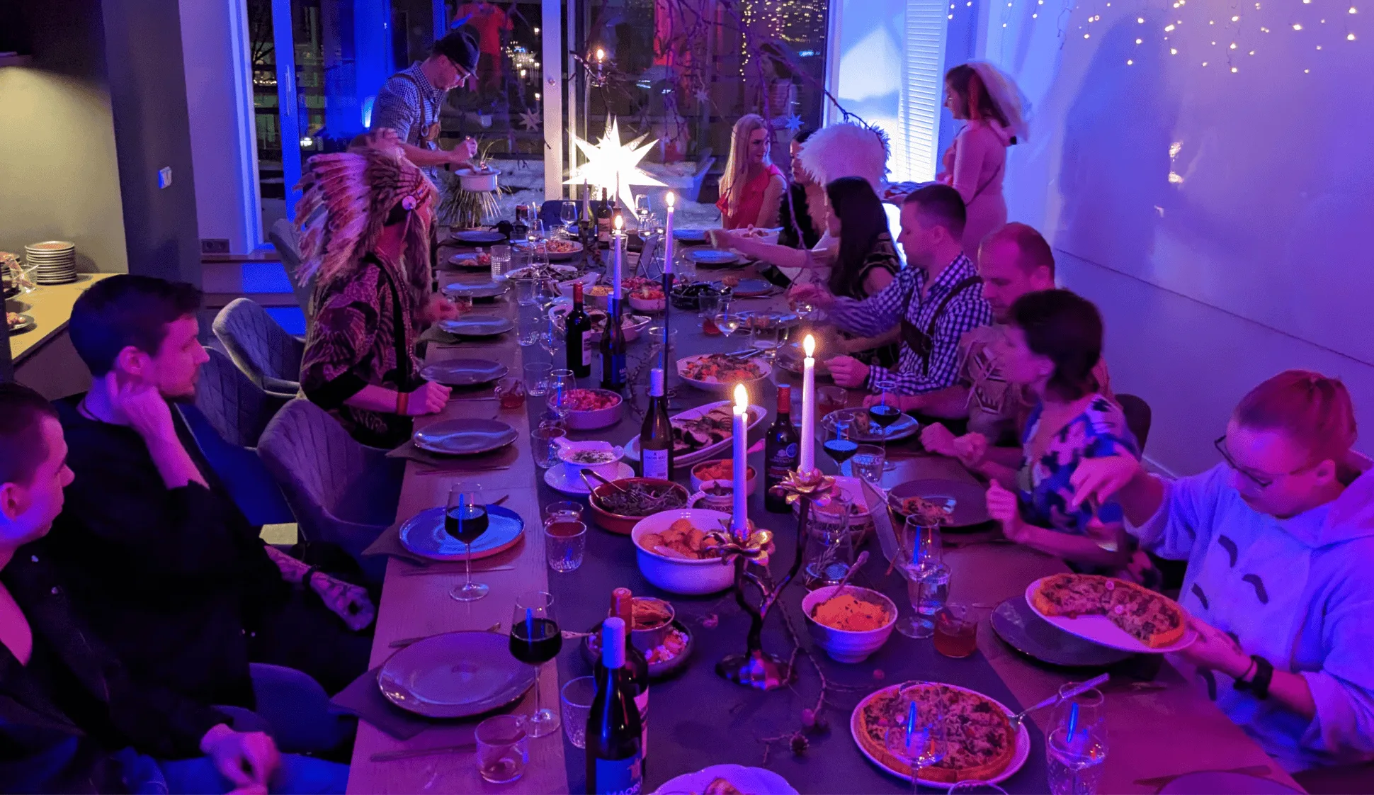 A photo of Artify's team sitting behind a long table, celebrating